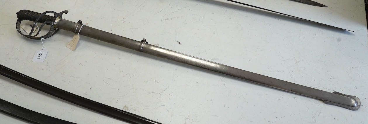A late Victorian Royal Artillery officer’s sword by Wilkinson, No.25179, etched with regimental device, Royal Arms, owner’s crest and motto, blade 88.5cm. Condition - poor condition in a good scabbard.